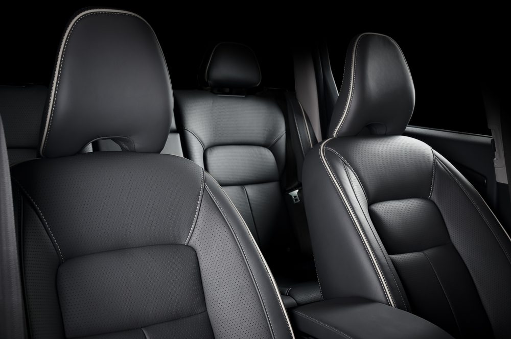 Luxury car inside. Interior of prestige modern car. Comfortable leather seats. Black perforarated leather cockpit.
