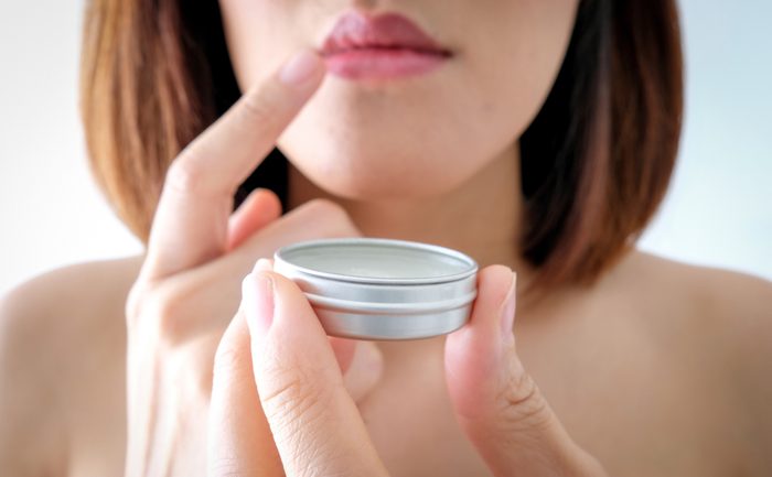 beautiful young asian woman apply lip balm care .make up cosmetic.beauty fashion.