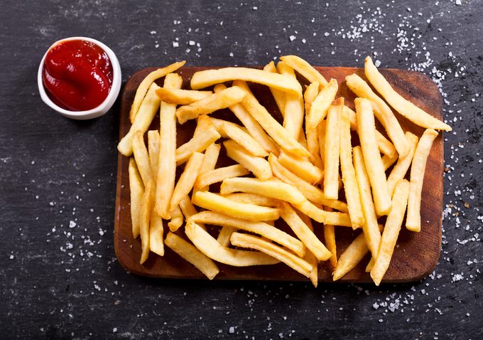 French fries with ketchup on dark background