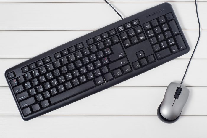 Keyboard mouse from computer on white wooden background isolation