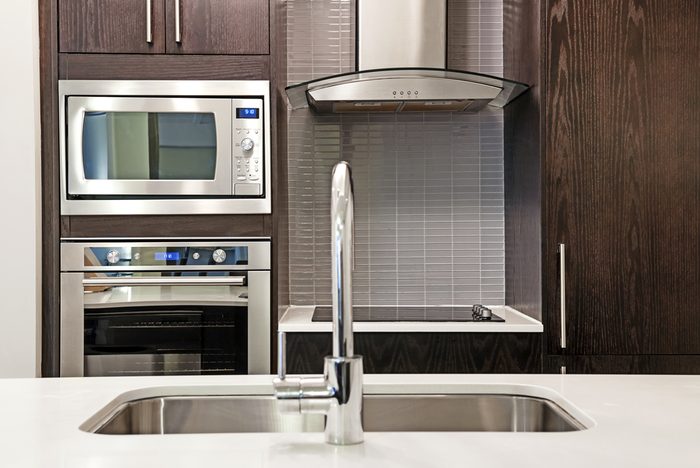 Modern luxury kitchen interior with stone countertop and stainless steel appliances