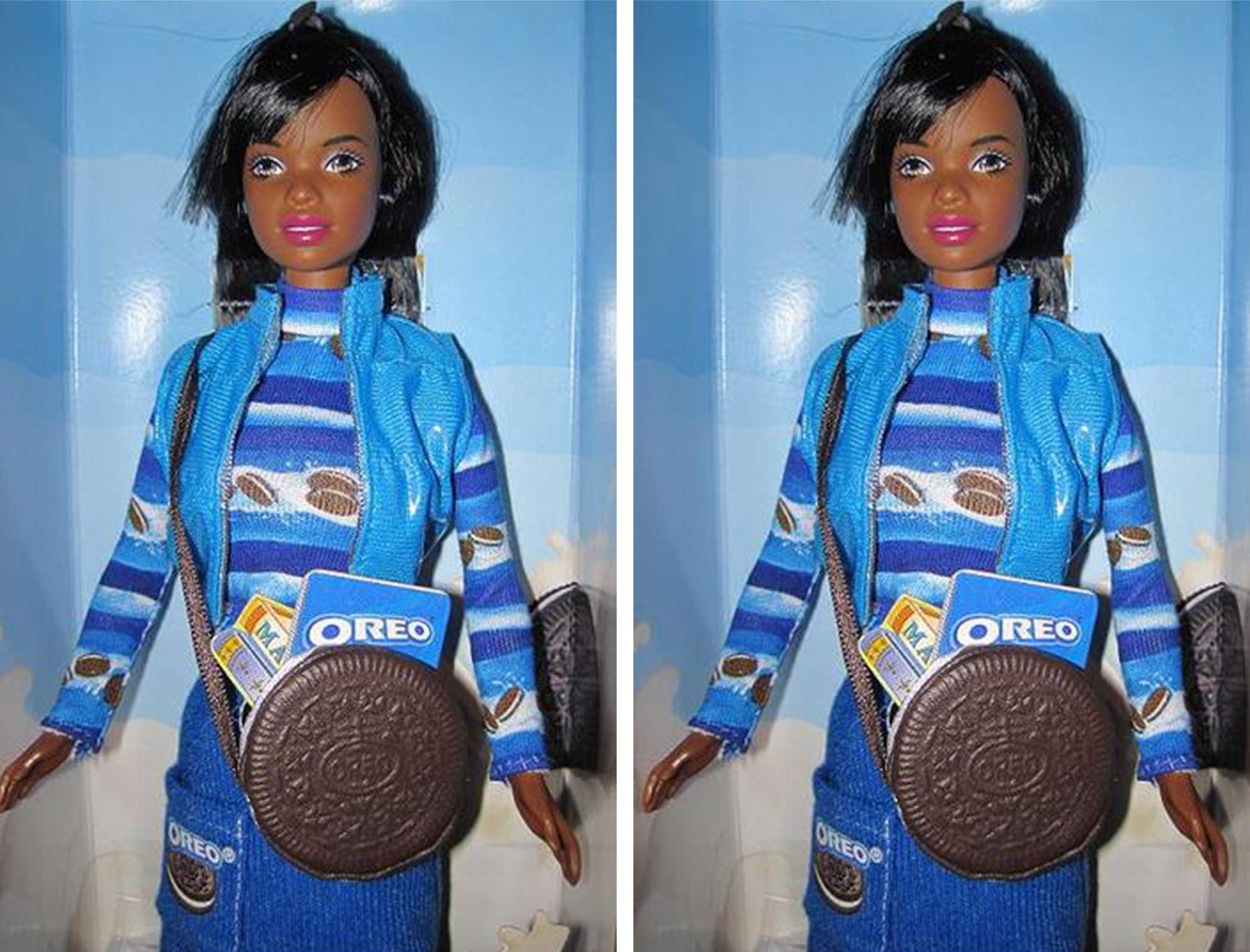 Doll stands wearing a blue-striped outfit with Oreo patterns, holding a bag resembling an Oreo cookie, in a blue, illustrated packaging background.