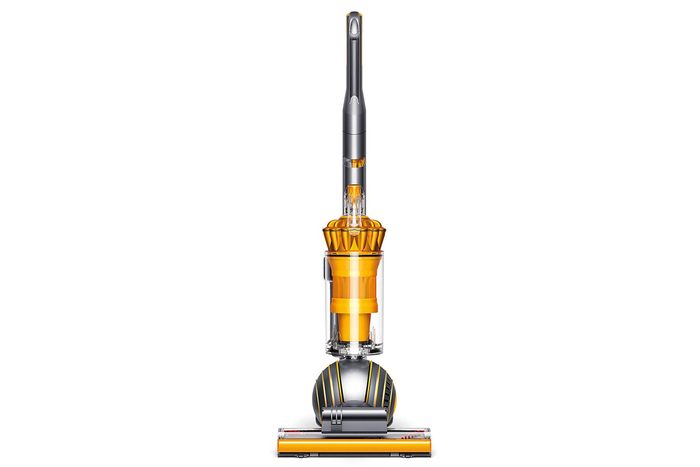 Vacuum cleaner stands upright, featuring a yellow and gray design with a spherical base on a plain white background.