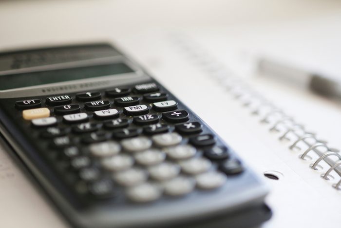 Homework background. Super close up of a calculator on a notebook.