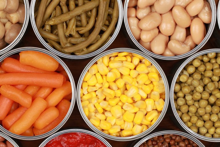 Different kinds of vegetables such as corn, peas and tomatoes in cans