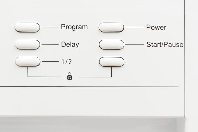 Control panel with buttons labeled Program, Delay, 1/2, Power, Start/Pause, arranged in a white, minimalist appliance interface.