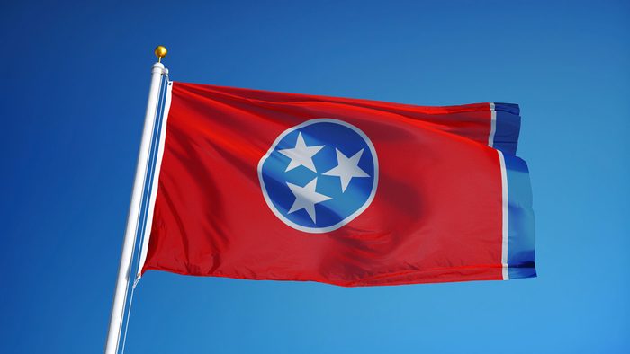 Tennessee (U.S. state) flag waving against clear blue sky, close up, isolated with clipping path mask alpha channel transparency, perfect for film, news, composition