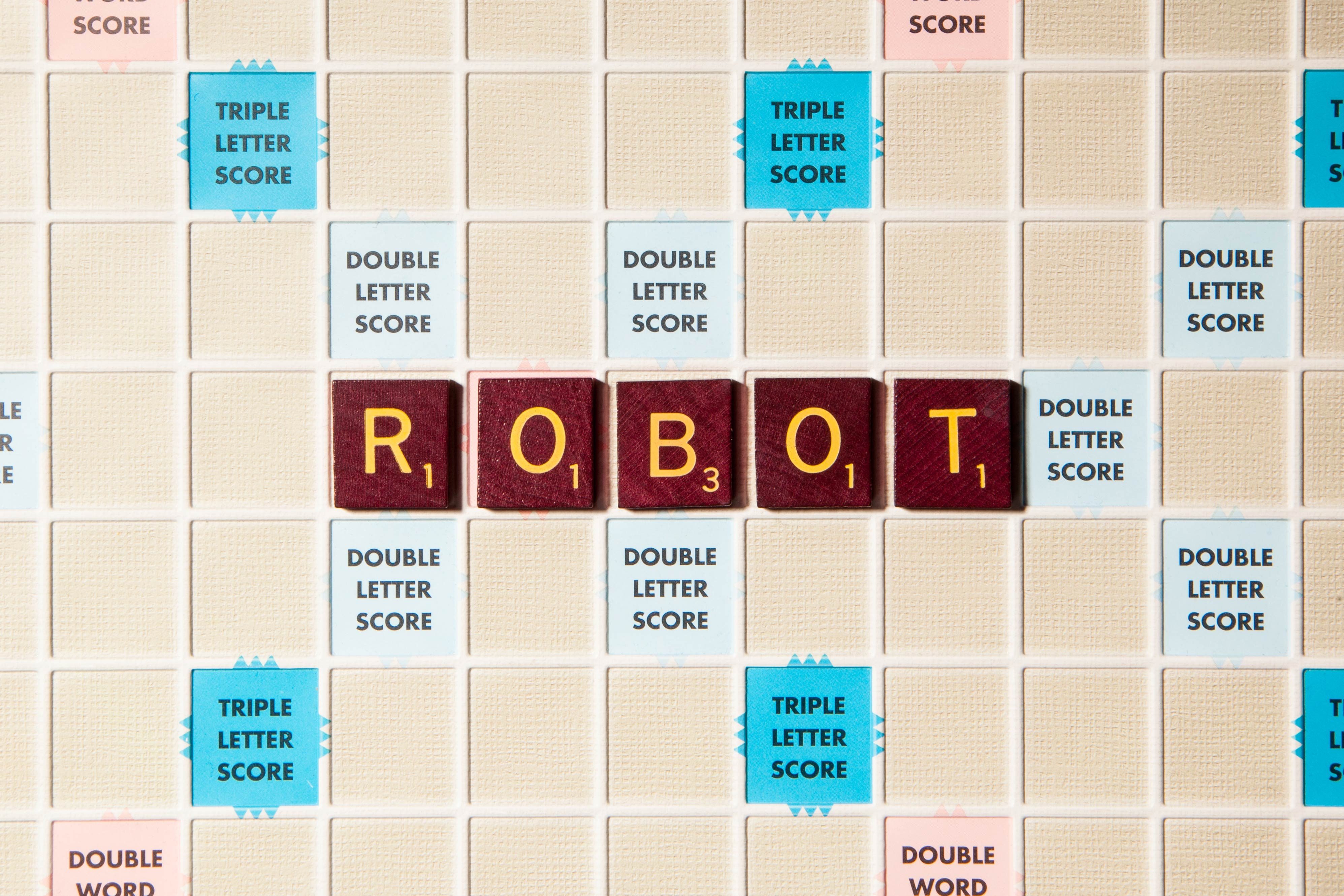 Tiles spell "ROBOT" on a Scrabble board, surrounded by various score multiplier squares, set in a grid pattern.