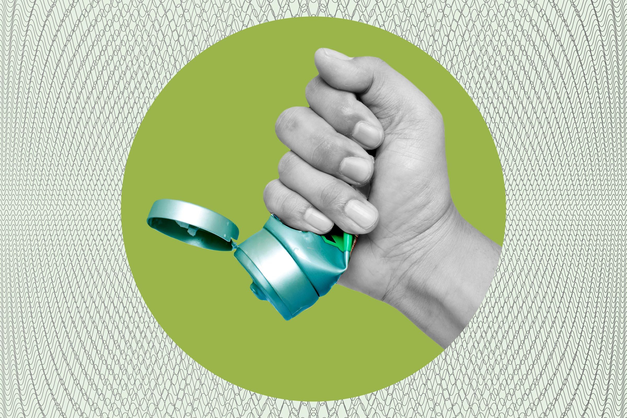 Hand holds open shampoo bottle, ready to squeeze, against green circle and patterned background.