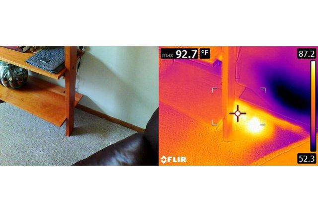 Wooden shelf sits against beige wall beside leather chair; infrared thermal image shows heat spot on the floor near shelf base.