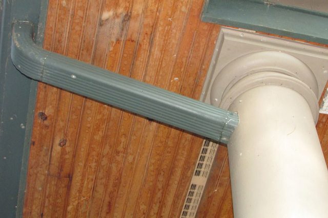 Column supports an adjacent beam on a wooden ceiling with ridged texture.