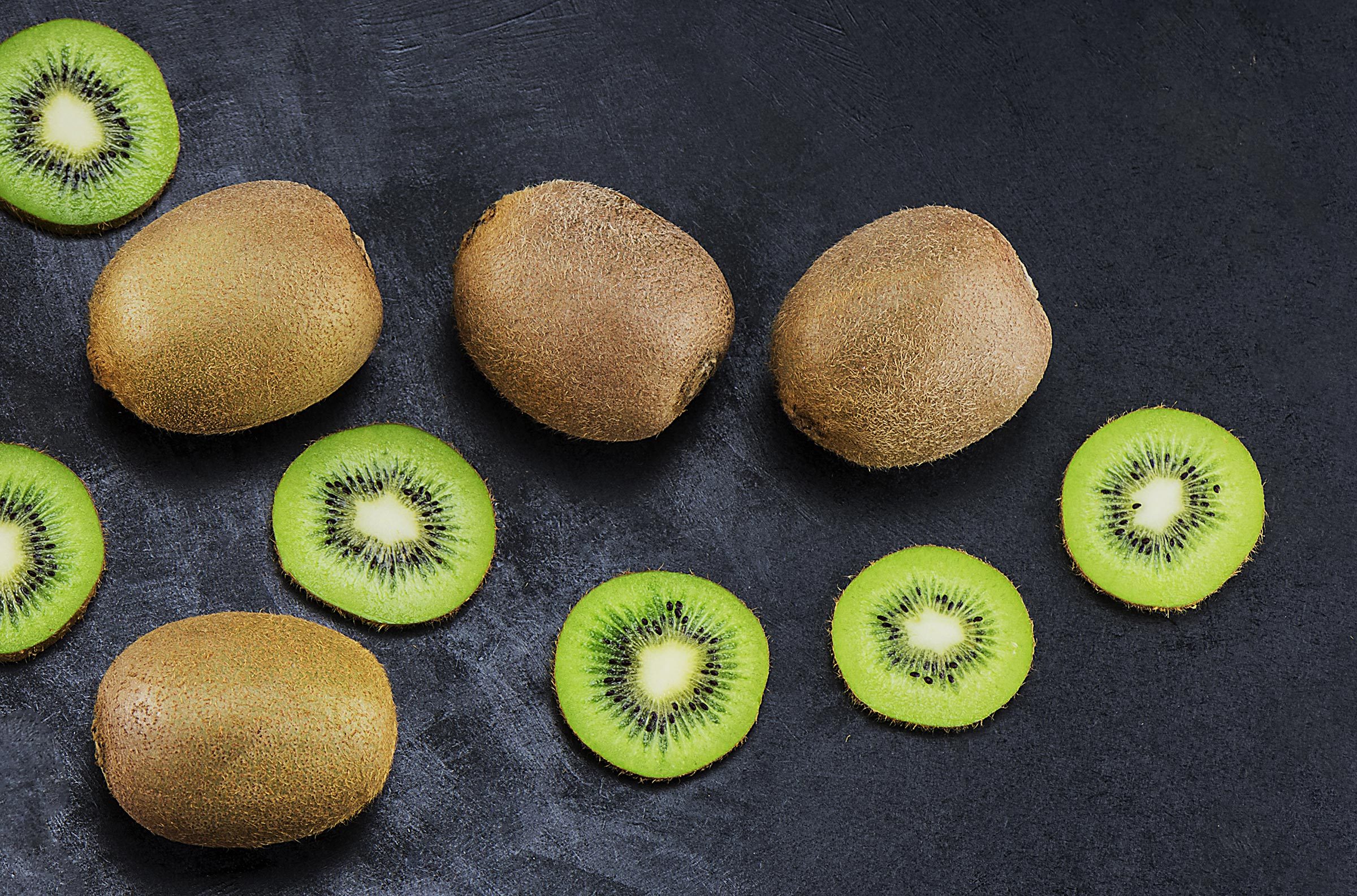 Fresh kiwi on a dark background, top view