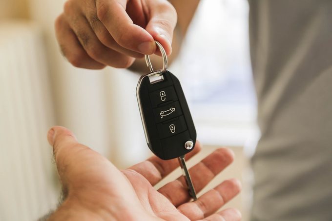 business man gives the car key