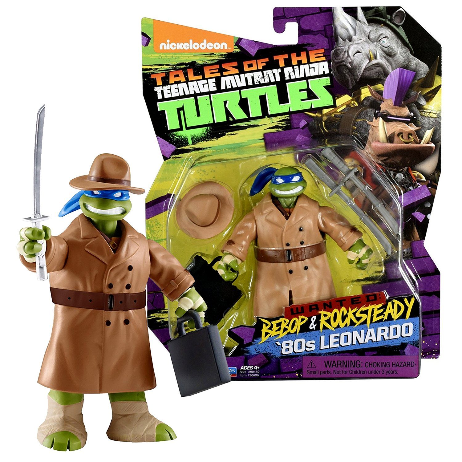 Action figure wears trench coat, hat, holds sword and briefcase; "Tales of the Teenage Mutant Ninja Turtles" packaging in colorful, branded background.
