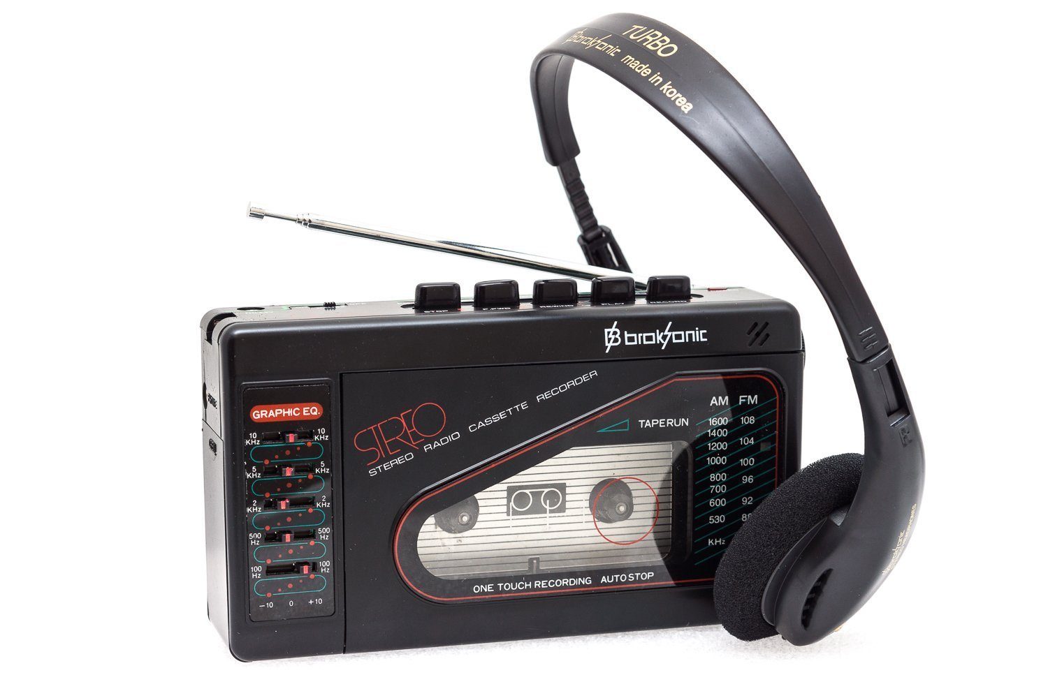 Cassette player rests with headphones attached; dials and buttons visible alongside analog display. Text includes "GRAPHIC EQ," "STEREO," and "Turbo, made in Korea."