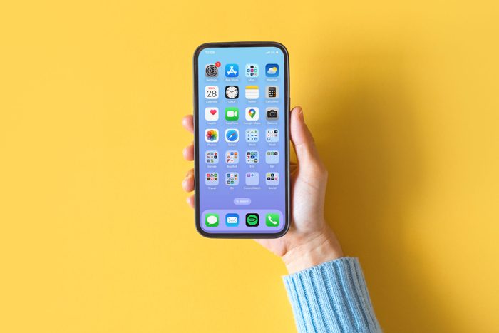 hand holding phone with apps on at the Home Screen