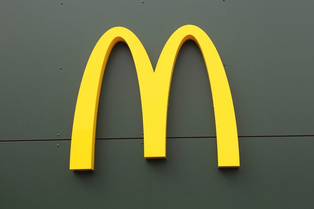 Yellow "M" logo displayed on a dark green wall.