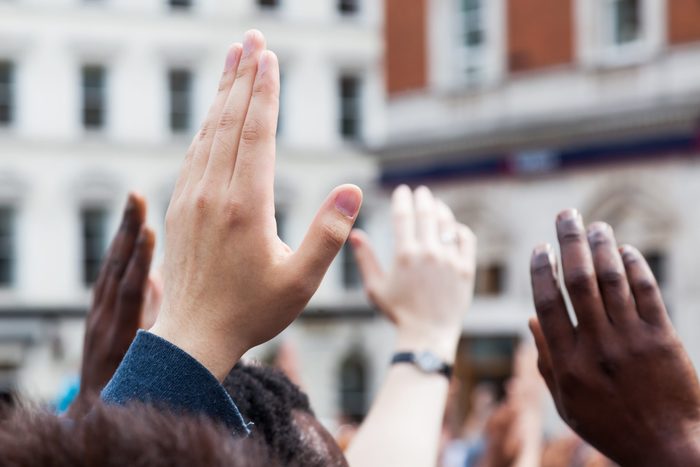 raised hands in a crowd of people