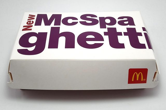 A closed white box displays bold 'New McSpaghetti' text and a McDonald's logo, against a plain background.