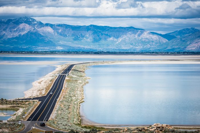 Road leading into Antelope Island State Park in Utah is on a barrier island causeway, crossing the Bridger Bay in Great Salt Lake