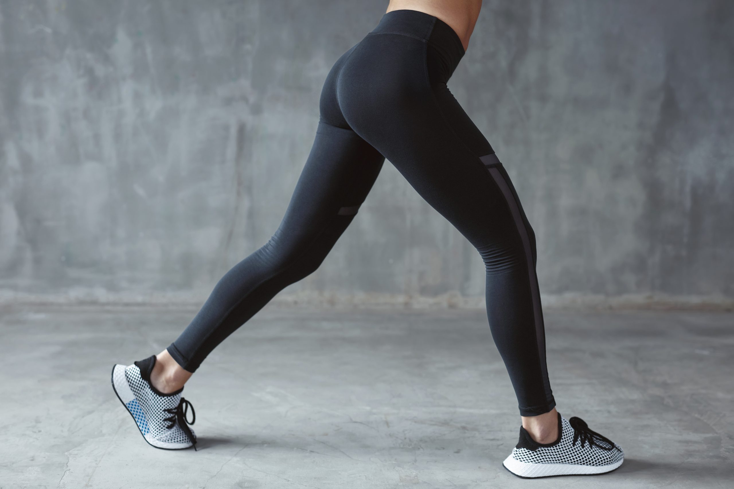 Fashion Sportswear. Fit Long Woman Legs In Leggings And Sneakers