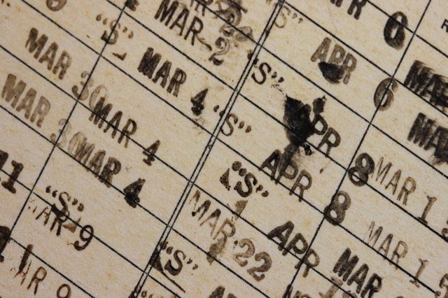 Grid calendar shows stamped dates "MAR" and "APR" with smudges, on yellowish paper, suggesting heavy use or alteration.