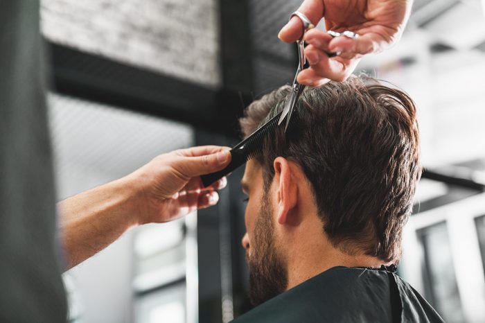 Hairdresser undergoing hairdo at salon