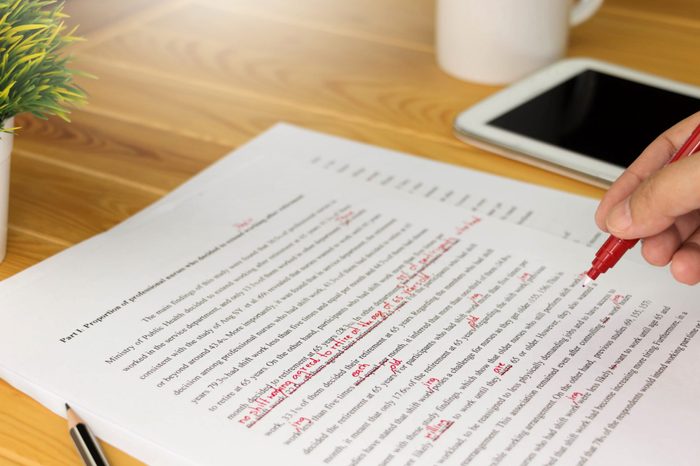 hand working on paper for proofreading