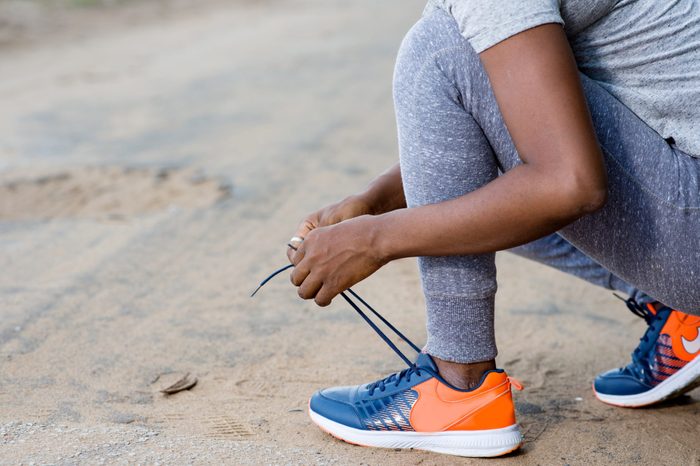 sporty girl tying laces.