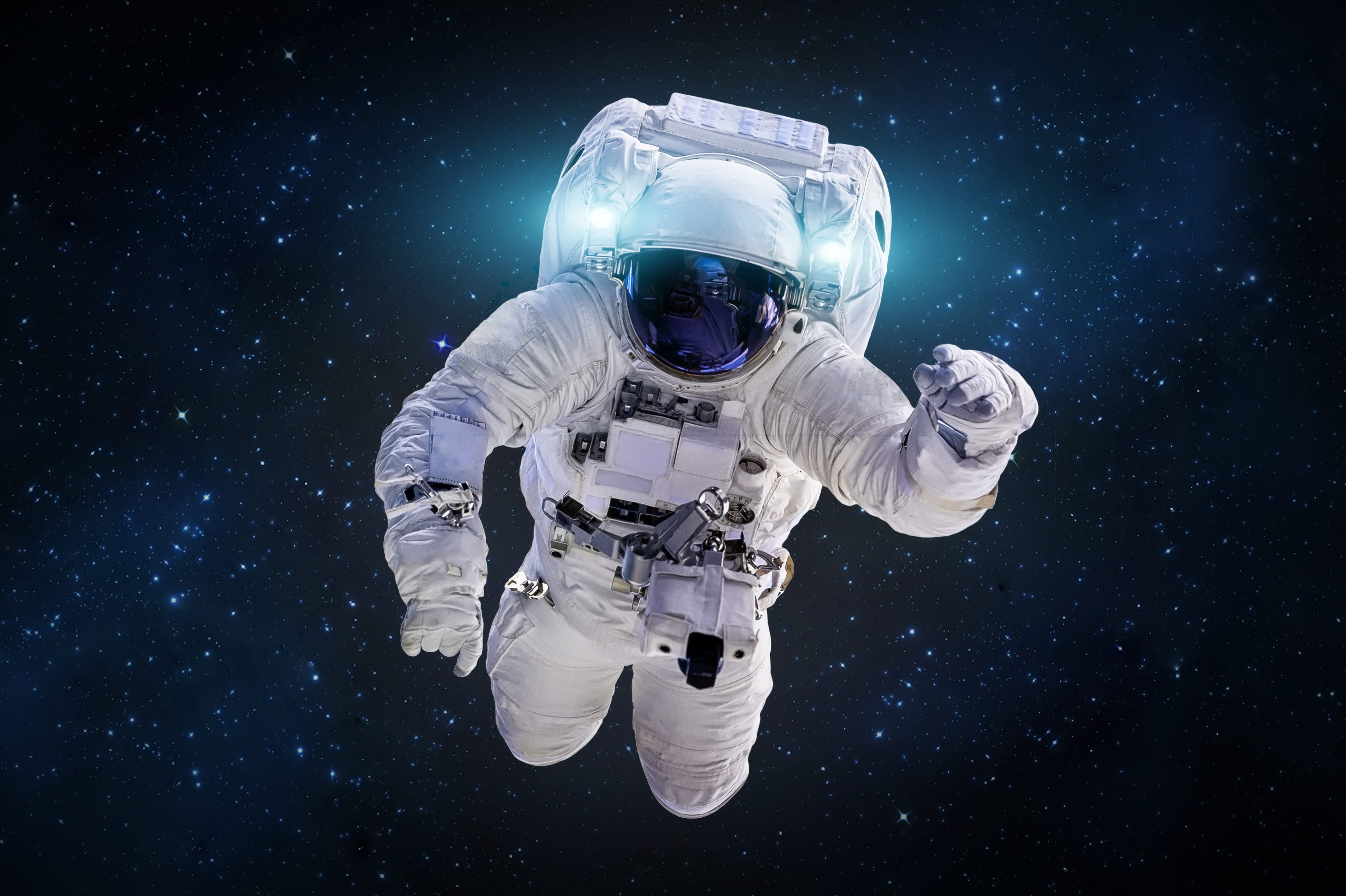 Astronaut floating in space, reaching forward amidst a backdrop of stars.