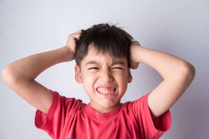 Little boy itchy his head stress face headache