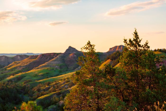 The sun sets over Scoria Point Overlook in Theodore Roosevelt National Park, North Dakota