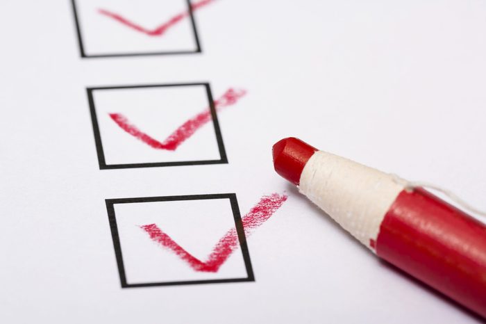 Checklist and pencil close-up on white background