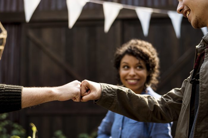 People fist bump hands sign power support