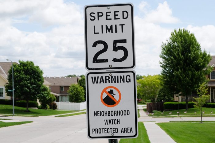 Neighborhood watch sign in a sunny Midwest suburb.