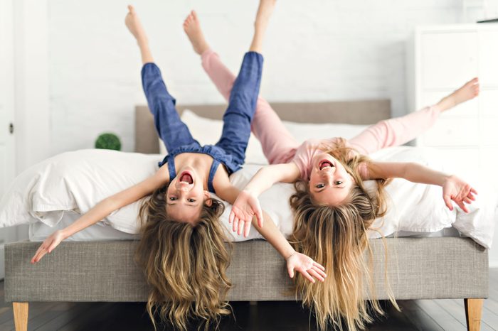 Portrait of two girls child friend in bed wearing pajamas