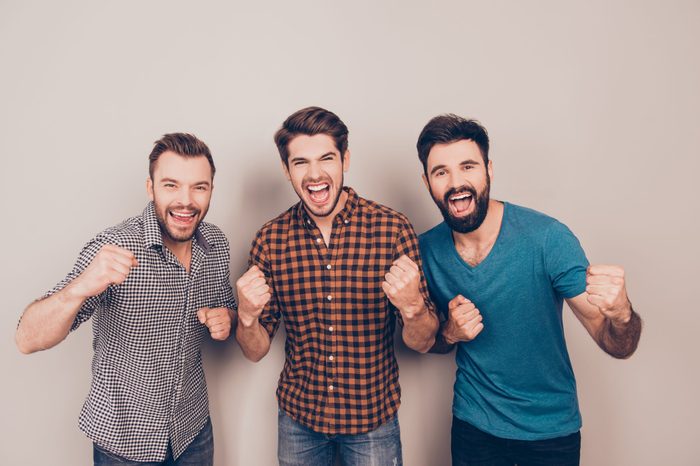 YEAH! three handsome screaming men showing their strong hands