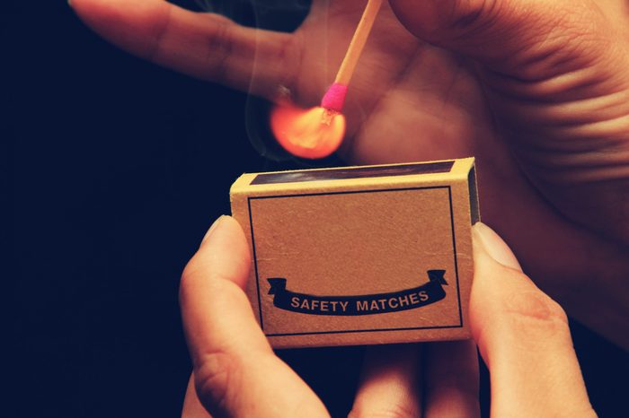 Light my Fire - someone holding a matchbox while striking a match