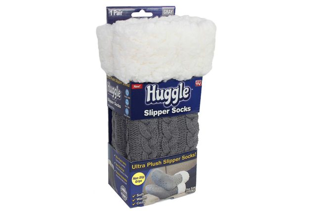 Gray slipper socks packaged in a blue box, labeled 