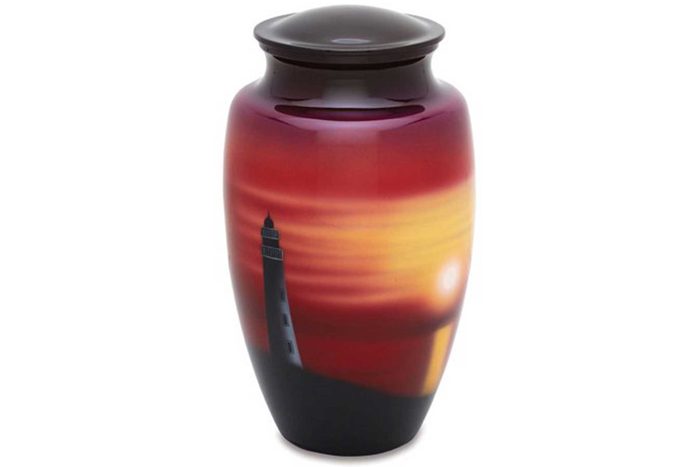 Vase displaying a sunset design with a silhouetted lighthouse, set against a gradient of red, orange, and yellow, on a white background.