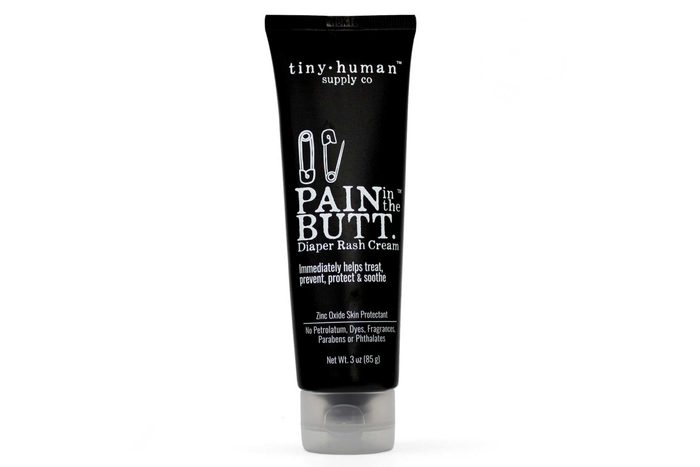 A black tube labeled â€œPain in the Butt Diaper Rash Creamâ€ displays white text, featuring zinc oxide, free from petrochemicals, dyes, fragrances, parabens, and phthalates.