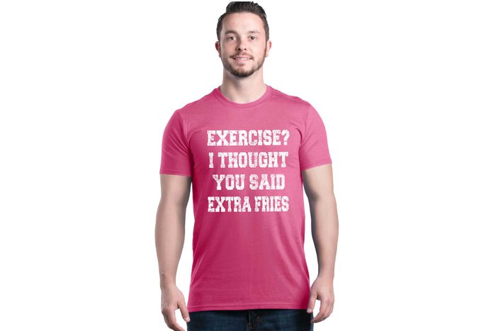 A person wears a pink T-shirt displaying the humorous text: 