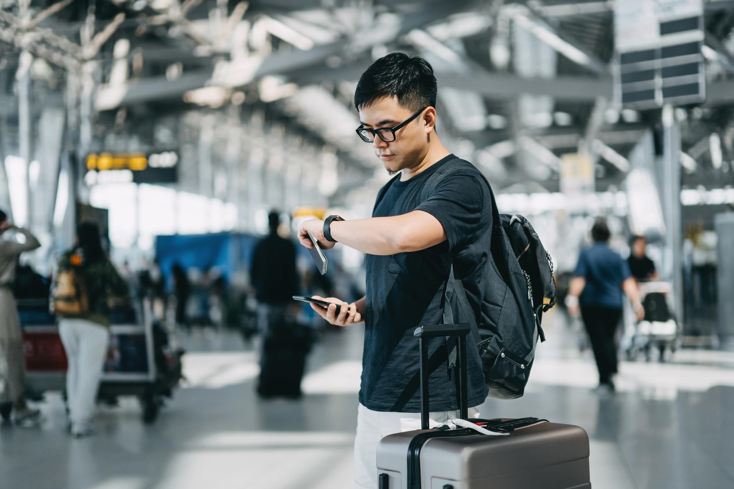 man checking his watch at an airport