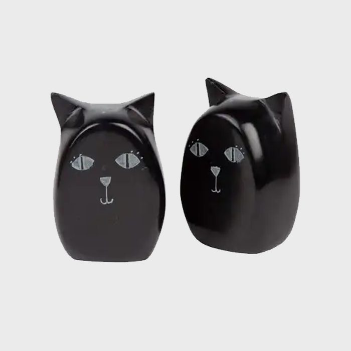 Two black ceramic cat figurines stand side by side, displaying stylized faces, against a plain light gray background.