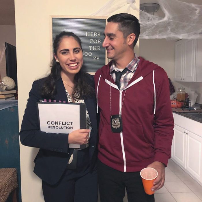 Two people stand together; one holds a 