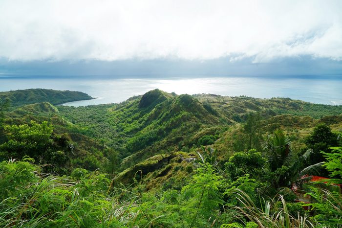 An observation deck with a very old jungle forest and blue sea. Cetti Bay, Guam
