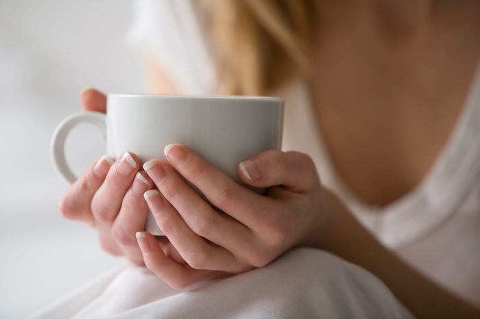 Woman's hands holding a cup