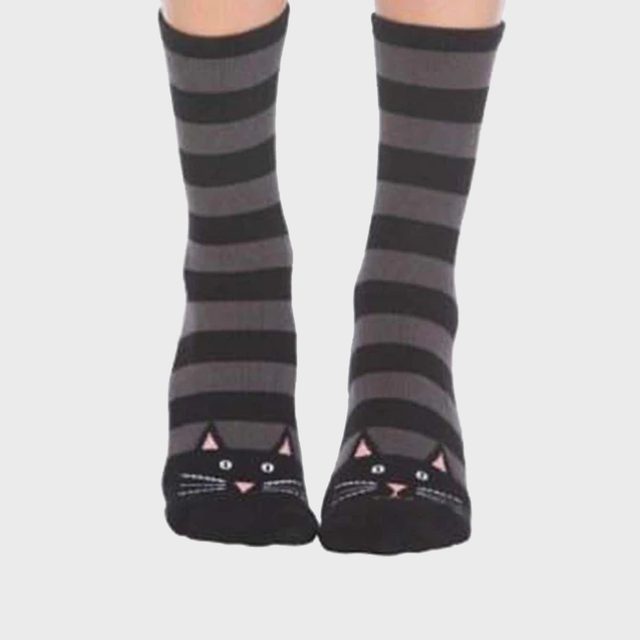 Striped socks feature cat faces at the toes, worn on feet, with a plain white background context.