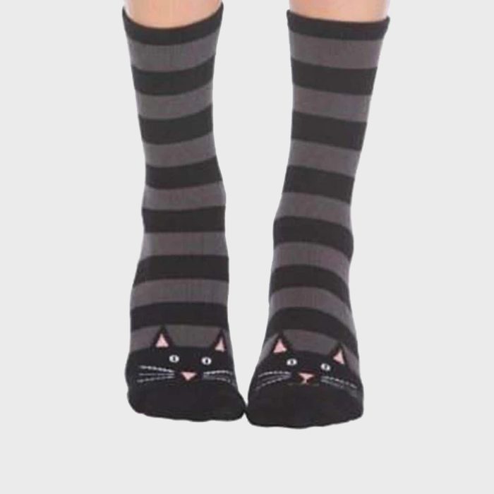 Striped socks feature cat faces at the toes, worn on feet, with a plain white background context.