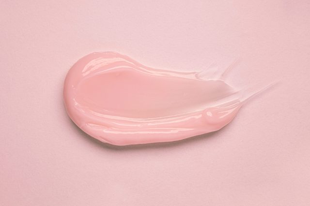 Pink cream swirled smoothly on a matching pink surface.